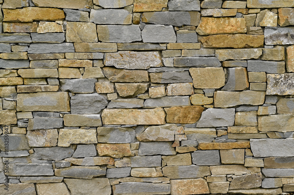 A brick wall made of stones of different shapes. background A brick wall made of stones of different shapes. background