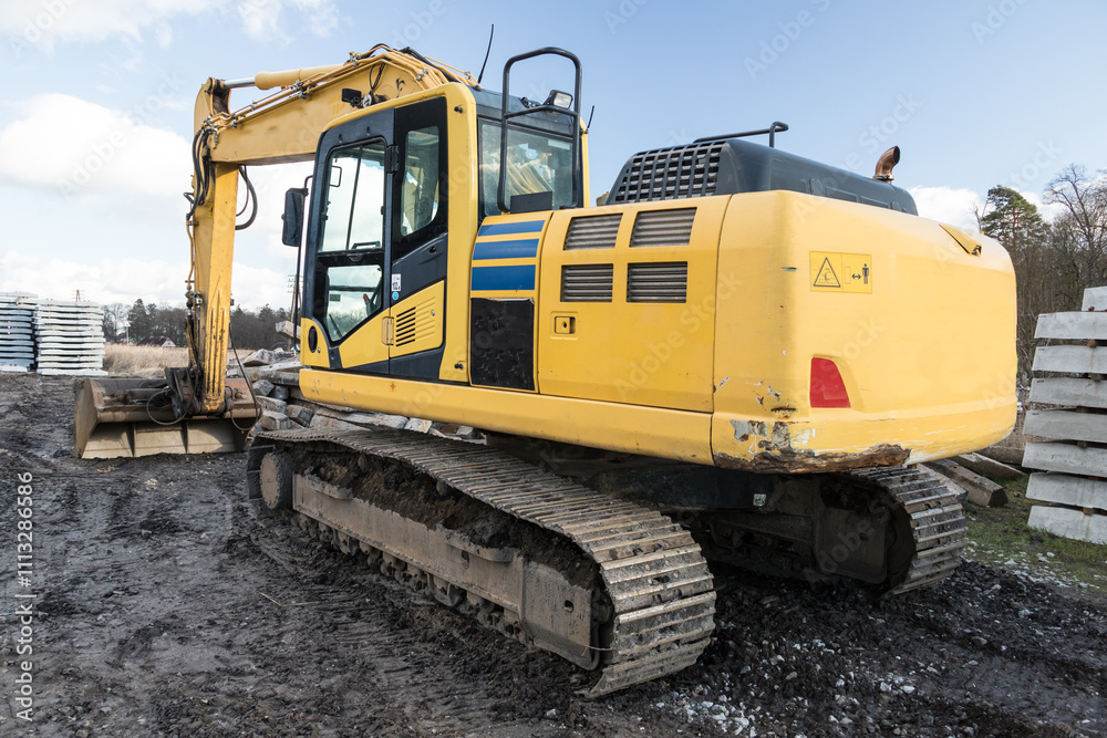 yellow excavator standing on the construction site yellow excavator standing on the construction site