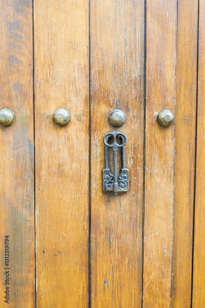 Close up of old Key in wooden door at home, Brown Wood Front Door with Ornate Brass Skeleton Key,copy space.. Close up of old Key in wooden door at home, Brown Wood Front Door with Ornate Brass Skeleton Key,copy space..