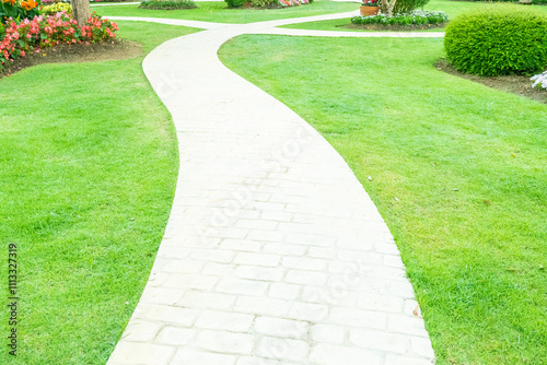 Walkway pathway s curve in public park,Lawn with curved paved garden path,Garden landscape design in flower garden,Selective focus,copy space. photo