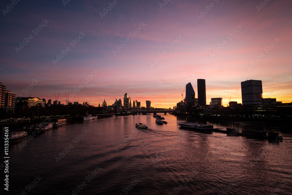 London cityscape reflecting on thames during colorful sunrise London cityscape reflecting on thames during colorful sunrise