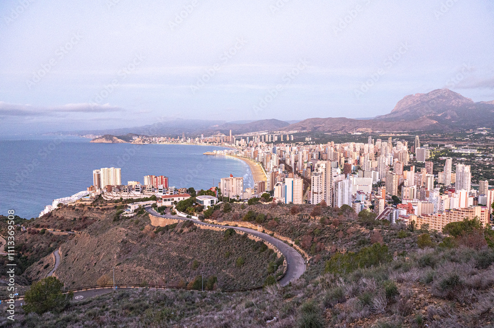 Panorama in the Sunrise on a clear day over Benidorm in Spain from the Mirador de la Cruz.