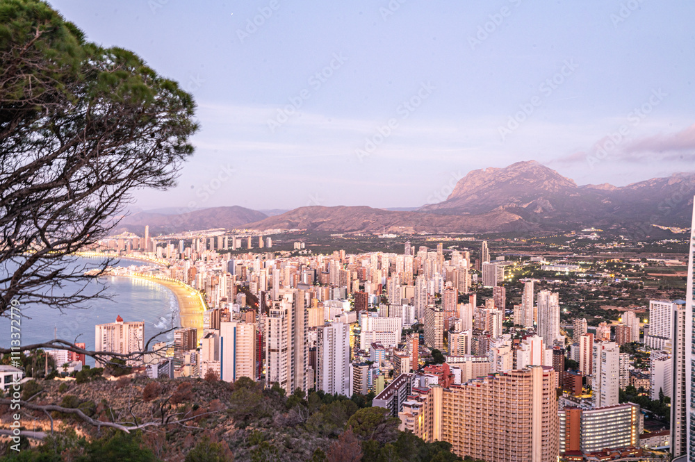 Panorama in the Sunrise on a clear day over Benidorm in Spain from the Mirador de la Cruz.