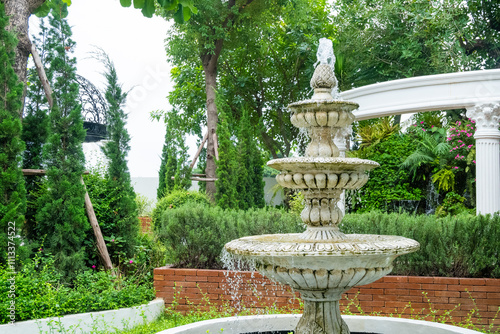 Outdoor water fountain multi-tiered in the park,The three tiered fountain in english garden. photo