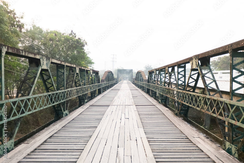 Old wooden Bridge with old railway ocated near street road and river. Old wooden Bridge with old railway ocated near street road and river.