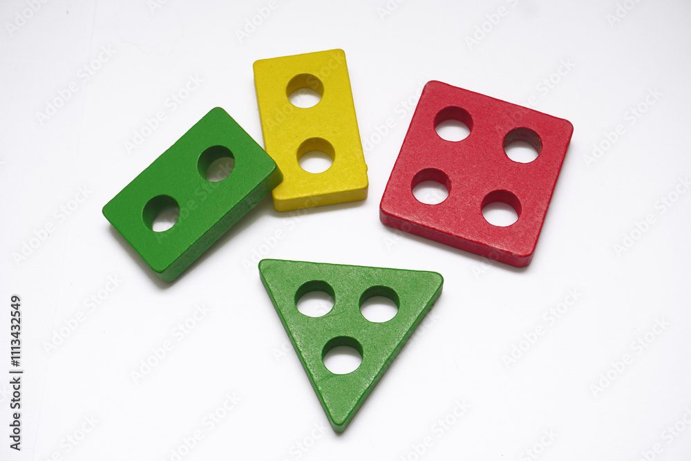 Stack of colorful wooden block toys on white, educational creative fun games Stack of colorful wooden block toys on white, educational creative fun games