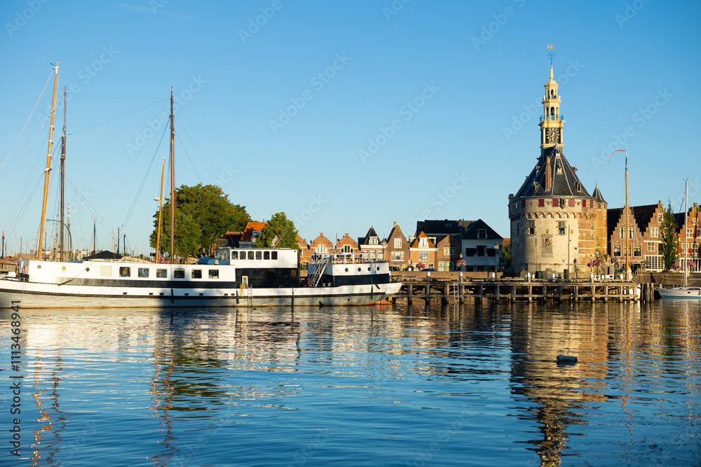 Obraz premium View of Hoofdtoren from lakeside on northwestern shore of Markermeer, Netherlands. Tower beside quay in Hoorn.