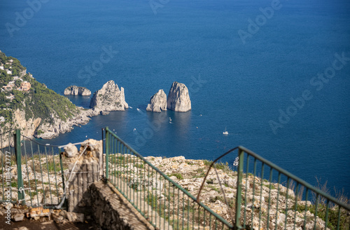 Aerial view of beautiful coastal cliffs  faraglioni di mezzo in Capri Island, Italy. photo