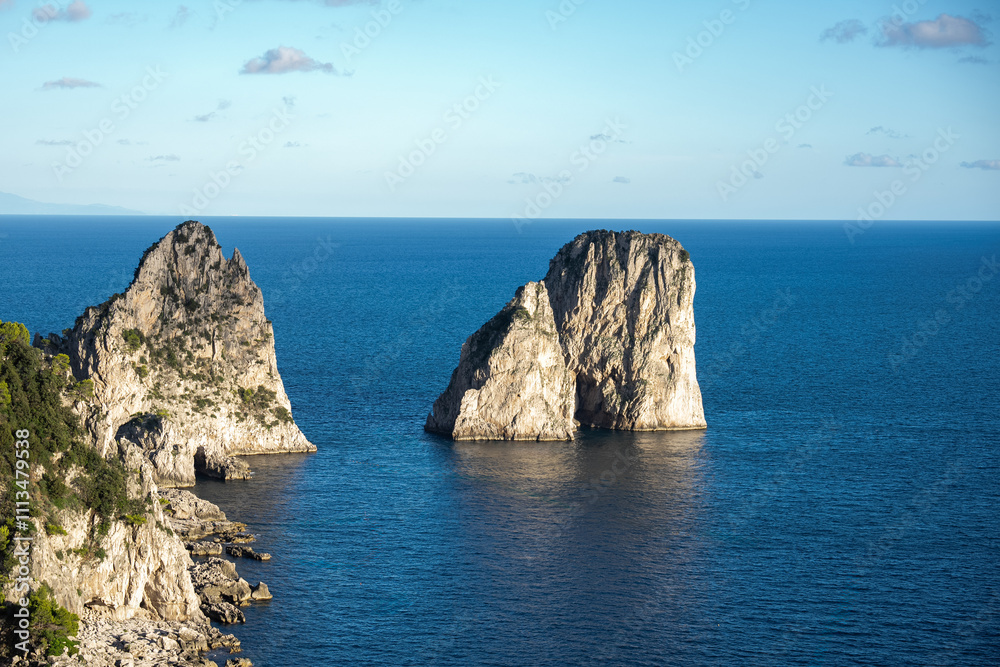 Aerial view of beautiful coastal cliffs faraglioni di mezzo in Capri Island, Italy. Aerial view of beautiful coastal cliffs faraglioni di mezzo in Capri Island, Italy.
