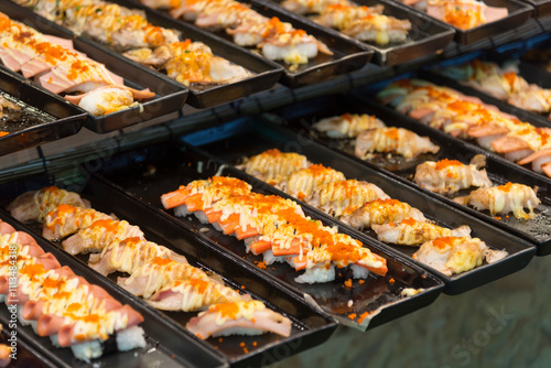 Closeup focus to row of sushi menu in the tray