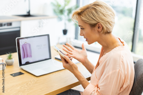 Caucasian woman expressing frustration over faulty online order. She calling customer service to report delivery issue or product problem. Image portrays dissatisfaction with e-commerce experience. photo