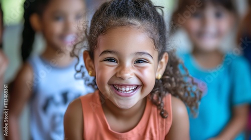 A young girl smiles happily as she looks at the camera.