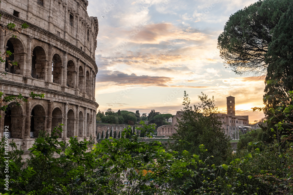 Fototapeta premium Arches archictecture of Colosseum (Colosseo) exterior with clouds and sky. Rome, Italy.