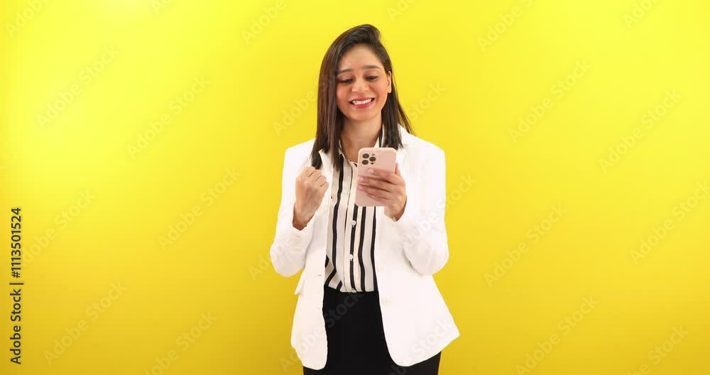 Beautiful Indian working business woman celebrating enjoy online victory, holds smart phone check e-mail app on device feel excited looking happy, receiving great deal by social media sms. Beautiful Indian working business woman celebrating enjoy online victory, holds smart phone check e-mail app on device feel excited looking happy, receiving great deal by social media sms.