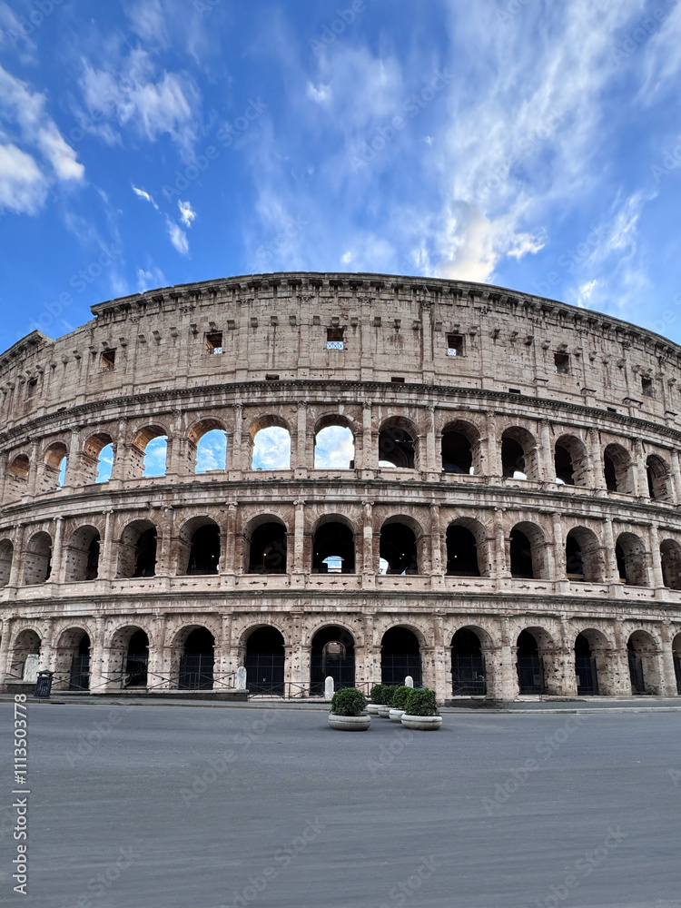 Obraz premium Arches archictecture of Colosseum (Colosseo) exterior with clouds and sky. Rome, Italy.