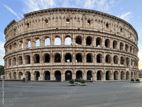 Arches archictecture of Colosseum (Colosseo) exterior with clouds and sky. Rome, Italy.