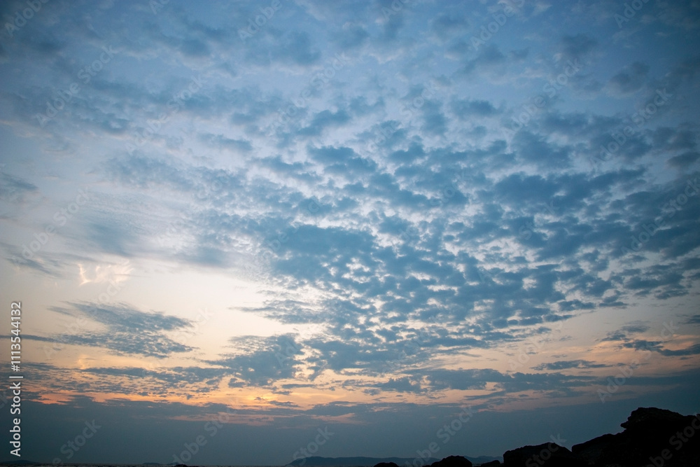 Naklejka premium fluffy clouds after sunset