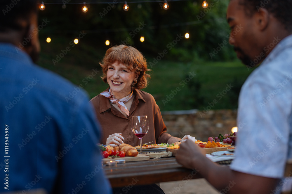 Beautiful redhead enjoying a dinner party with her friends Beautiful redhead enjoying a dinner party with her friends