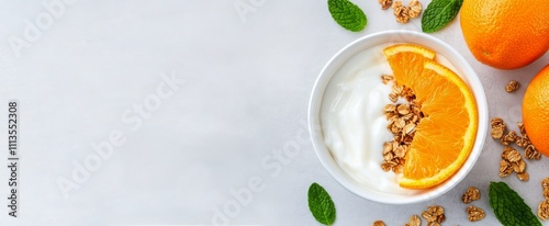 Healthy breakfast bowl with yogurt, granola, and fresh oranges on a light bac...