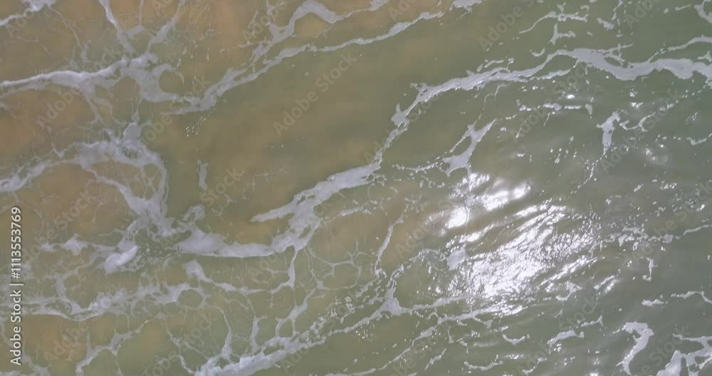Beautiful sea summer landscape, Waves sea water surface High quality video Bird's eye view,Drone top view waves crashing on sand beach,Nature ocean sea beach background Beautiful sea summer landscape, Waves sea water surface High quality video Bird's eye view,Drone top view waves crashing on sand beach,Nature ocean sea beach background