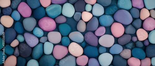 Colorful pebbles arranged artistically on a surface create an abstract art piece