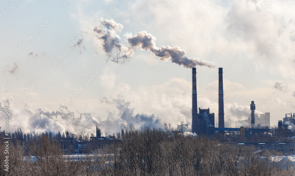A large industrial plant is spewing smoke into the sky A large industrial plant is spewing smoke into the sky