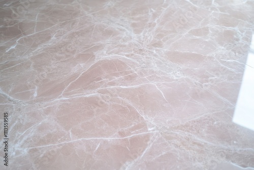 Wide-angle view of pale pink marble with light gray veins, creating a soft and elegant appearance across the floor.