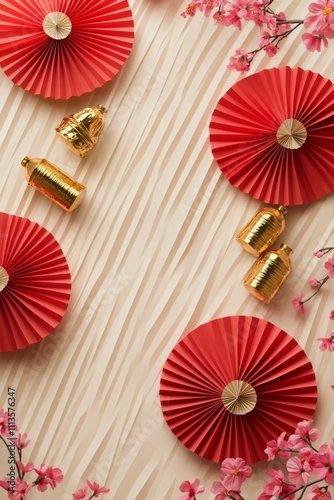 Decorative red paper fans and golden ornaments arranged with pink blossoms fo...