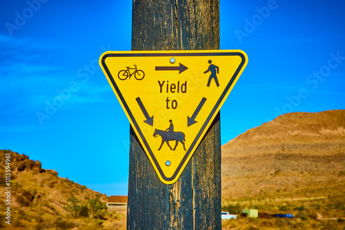 Yield Sign with Cyclist Pedestrian Horse Symbols Eye Level in Desert Landscape