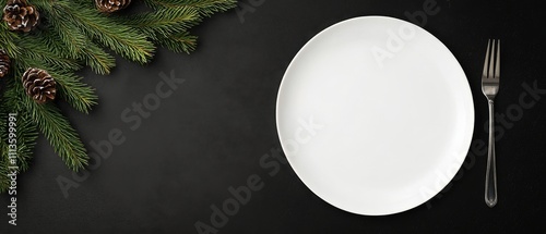 Empty plate on black table with pine branches and pine cones arranged artisti...
