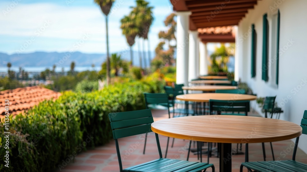 Obraz premium Picturesque outdoor seating area at a charming coastal cafe offering stunning views of the nearby ocean and a relaxing