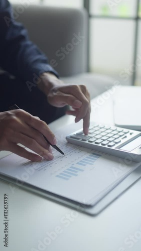 Man calculates finances by calculator pay bills taxes financial at home.
