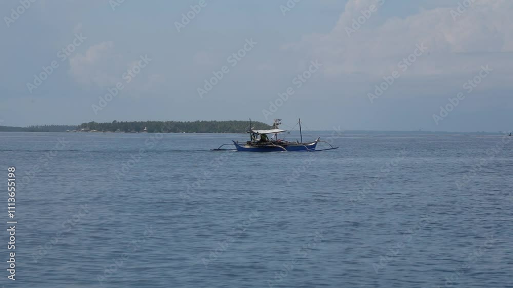 view of a traditional Filipino outrigger boat (bangka) with passengers, navigating the turquoise waters under a clear blue sky view of a traditional Filipino outrigger boat (bangka) with passengers, navigating the turquoise waters under a clear blue sky