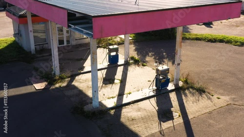 Wallpaper Mural Abandoned Gas Station with Weathered Pumps and Overgrown Vegetation Torontodigital.ca