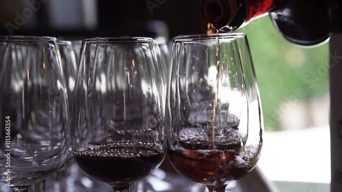 Pouring Red Wine On Glass Cup photo