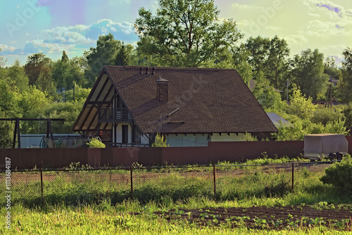 A small frame house with a brown roof covered with soft roofing, stylized as tiles.