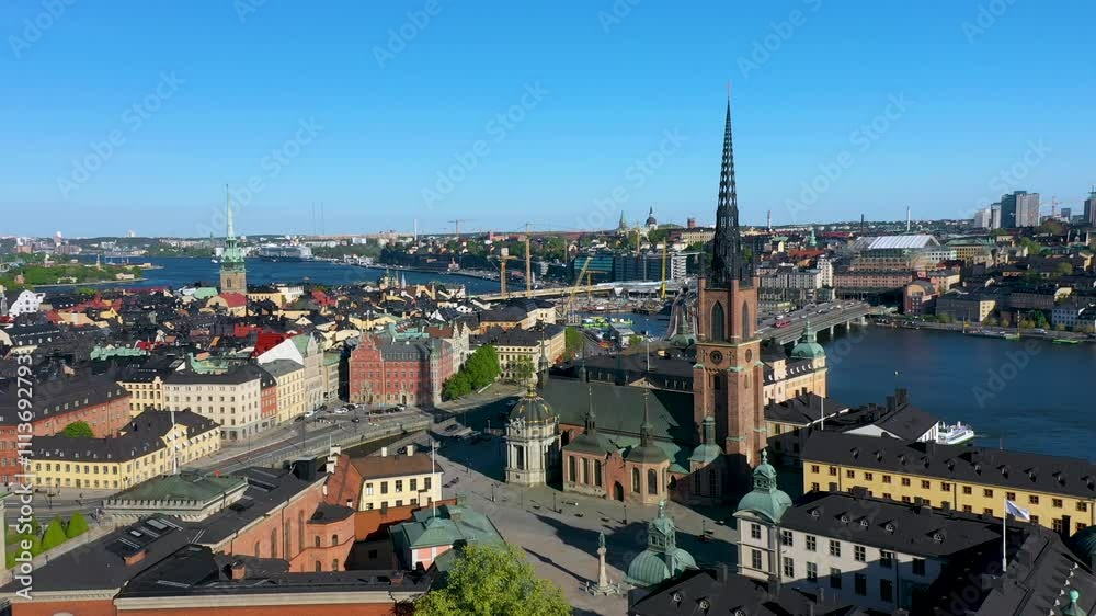 Camera pans over stockholm city center with riddarholmen church and lake malaren in the backgroundh