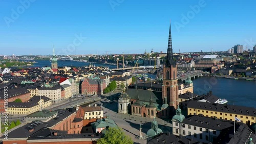 Camera pans over stockholm city center with riddarholmen church and lake malaren in the backgroundh