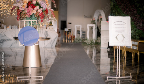 welcome board on the path leading to the wedding aisle with flower decorations