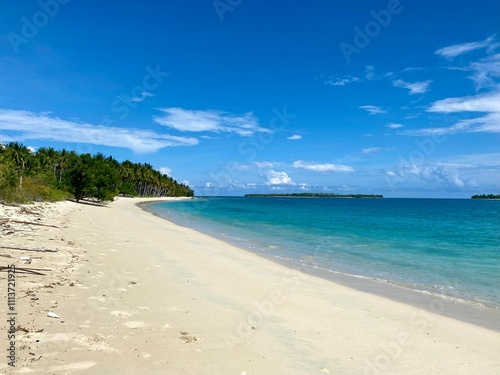 Beach travel vacation tropical paradise getaway on banggai island with idyllic pristine ocean crystal clear turquoise water lagoon. Pefect honeymoon destination background.