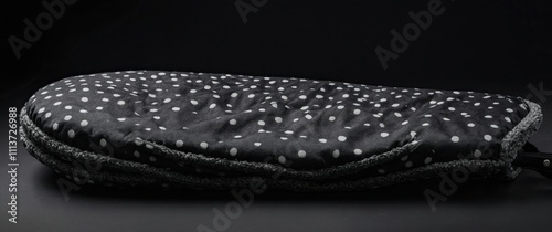 Elegant black floral oven mitt on a dark background, ideal for cooking and baking photo