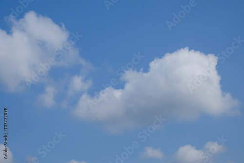 Abstract pattern and texture of white clouds clumped against a blue sky background. Copy space for graphic design. Natural pattern and texture background