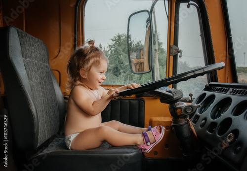 child in a car driving a kamaz photo