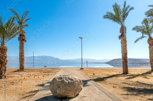Dead Sea, salty shore, caution sign for not safety swimming