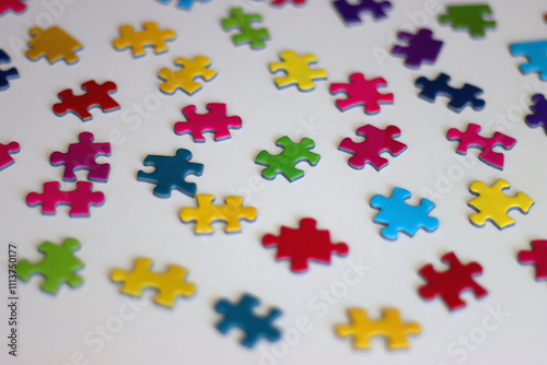 Colorful jigsaw puzzle pieces on white background. Selective focus.