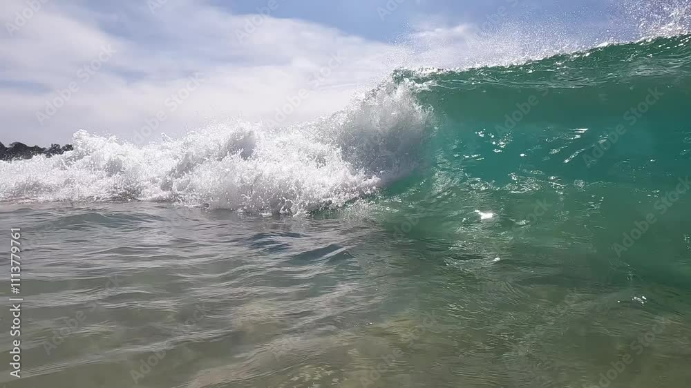 Close-up of big waves with splashing, on the ocean shore on a sunny summer day. Concept of exotic vacation, travel and summer adventures. Close-up of big waves with splashing, on the ocean shore on a sunny summer day. Concept of exotic vacation, travel and summer adventures.