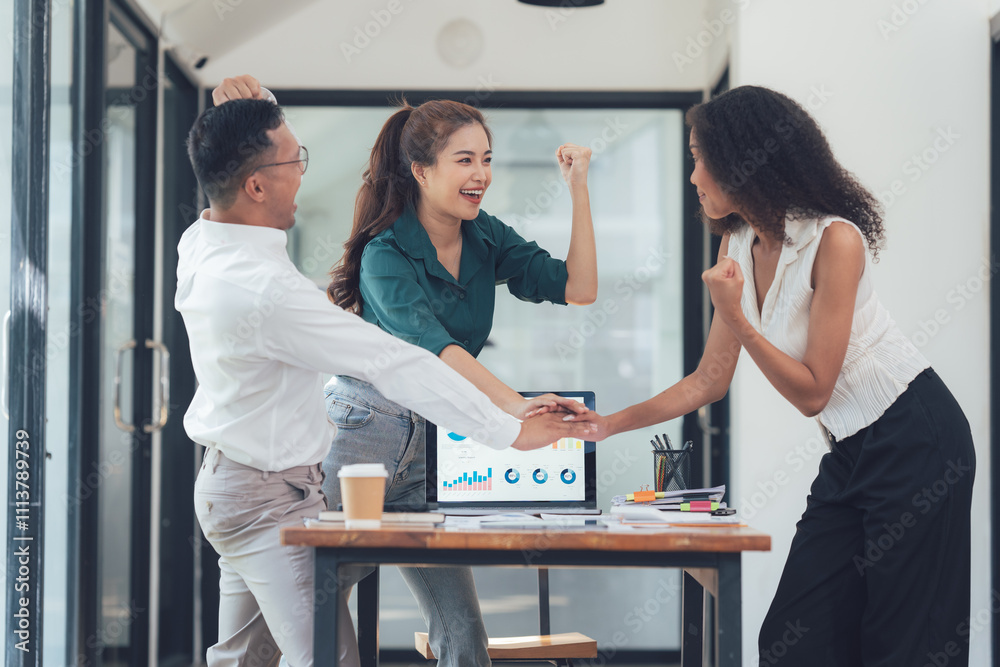 Office Celebration: A diverse team of professionals celebrates a shared success, their hands clasped together around a laptop displaying a positive graph. Office Celebration: A diverse team of professionals celebrates a shared success, their hands clasped together around a laptop displaying a positive graph.