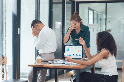 Stressful Business Meeting: A diverse team struggles with a project, overwhelmed by challenges and deadlines. The image conveys the pressure and intensity of modern business life. 
