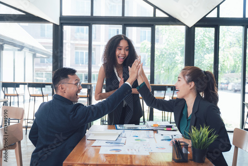 Business Success High Five: A diverse team of professionals shares a celebratory high five, radiating excitement and accomplishment. The moment captures the spirit of collaboration, unity.