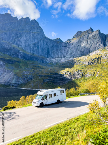 Scenic drive through norway's majestic mountains in a white camper van offers a breathtaking view of travel and adventure